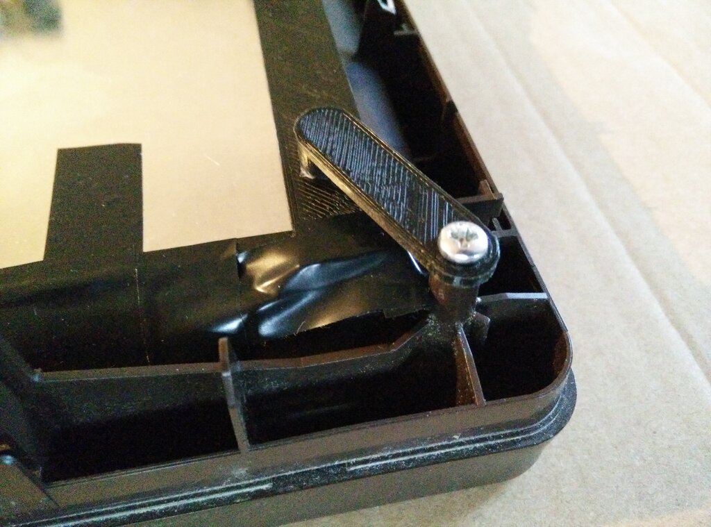 Close-up of a screen holder screwed to the frame